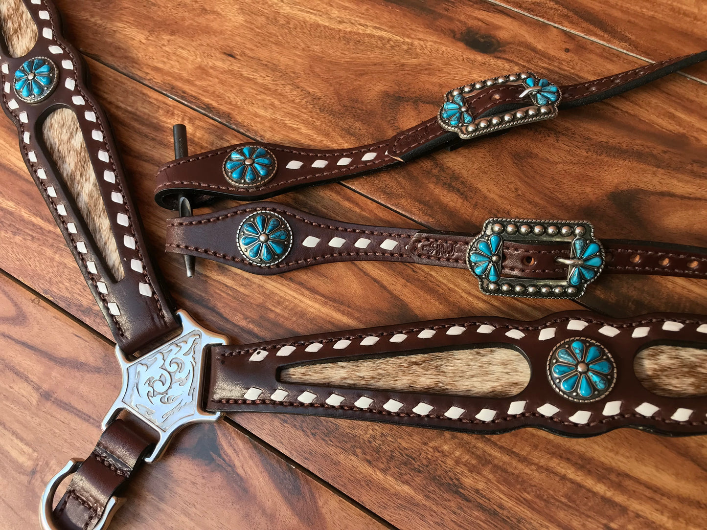 Buckstitch cowhide with turquoise flower
