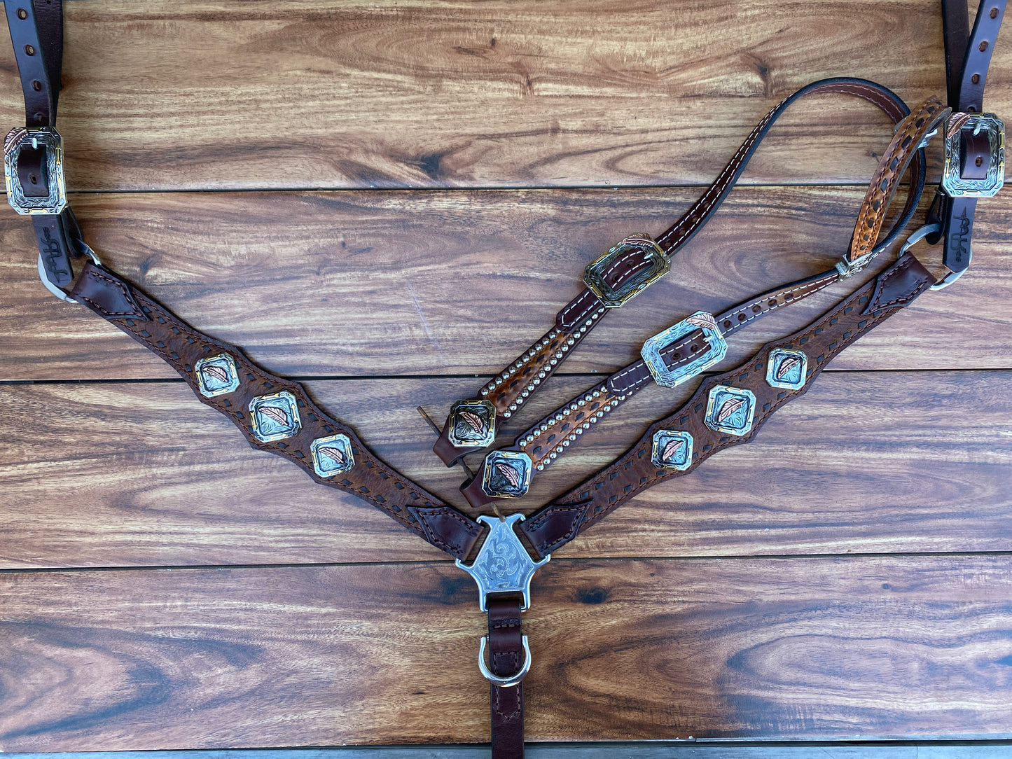Brown buckstitch with feather conchos