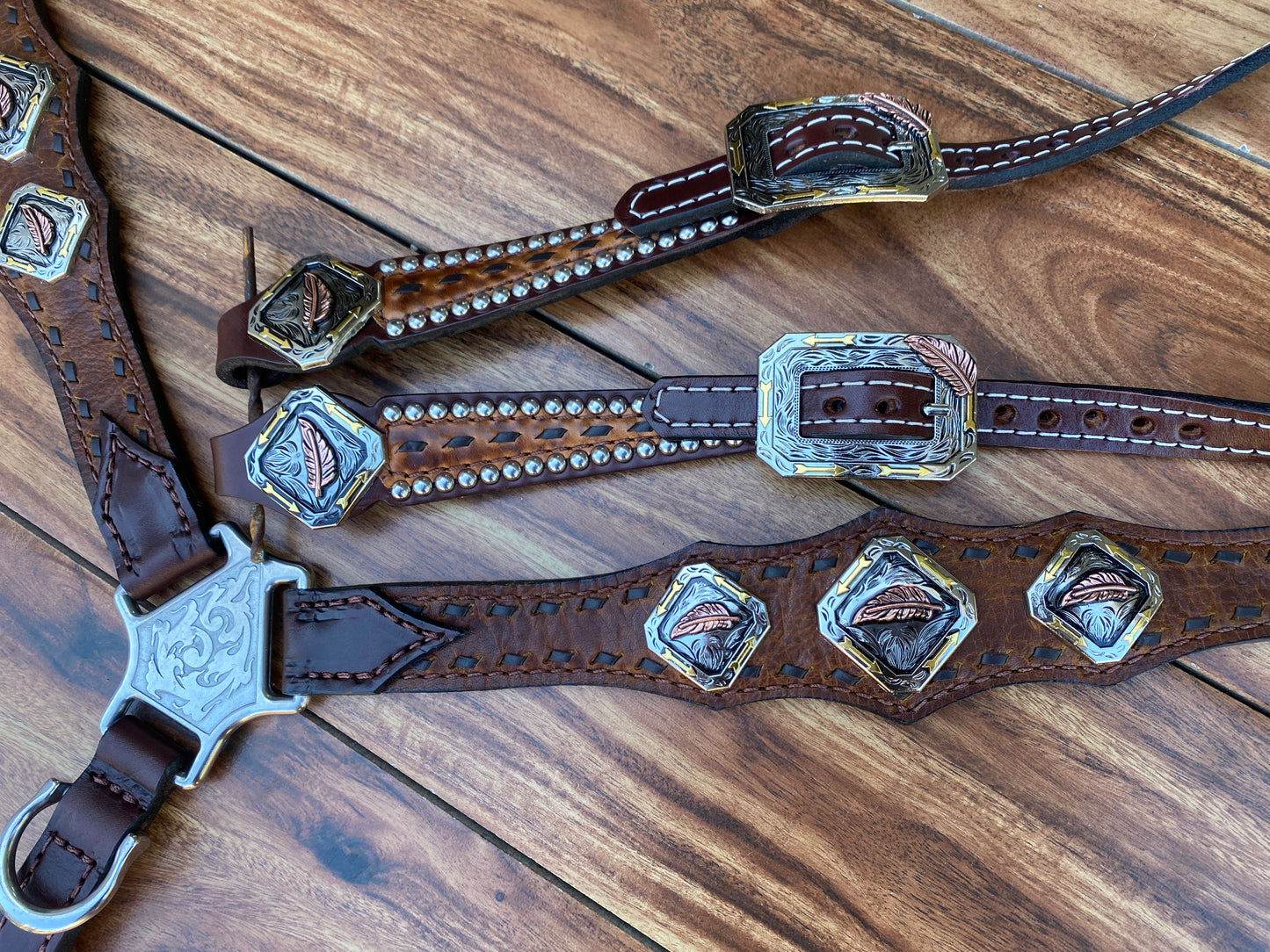Brown buckstitch with feather conchos