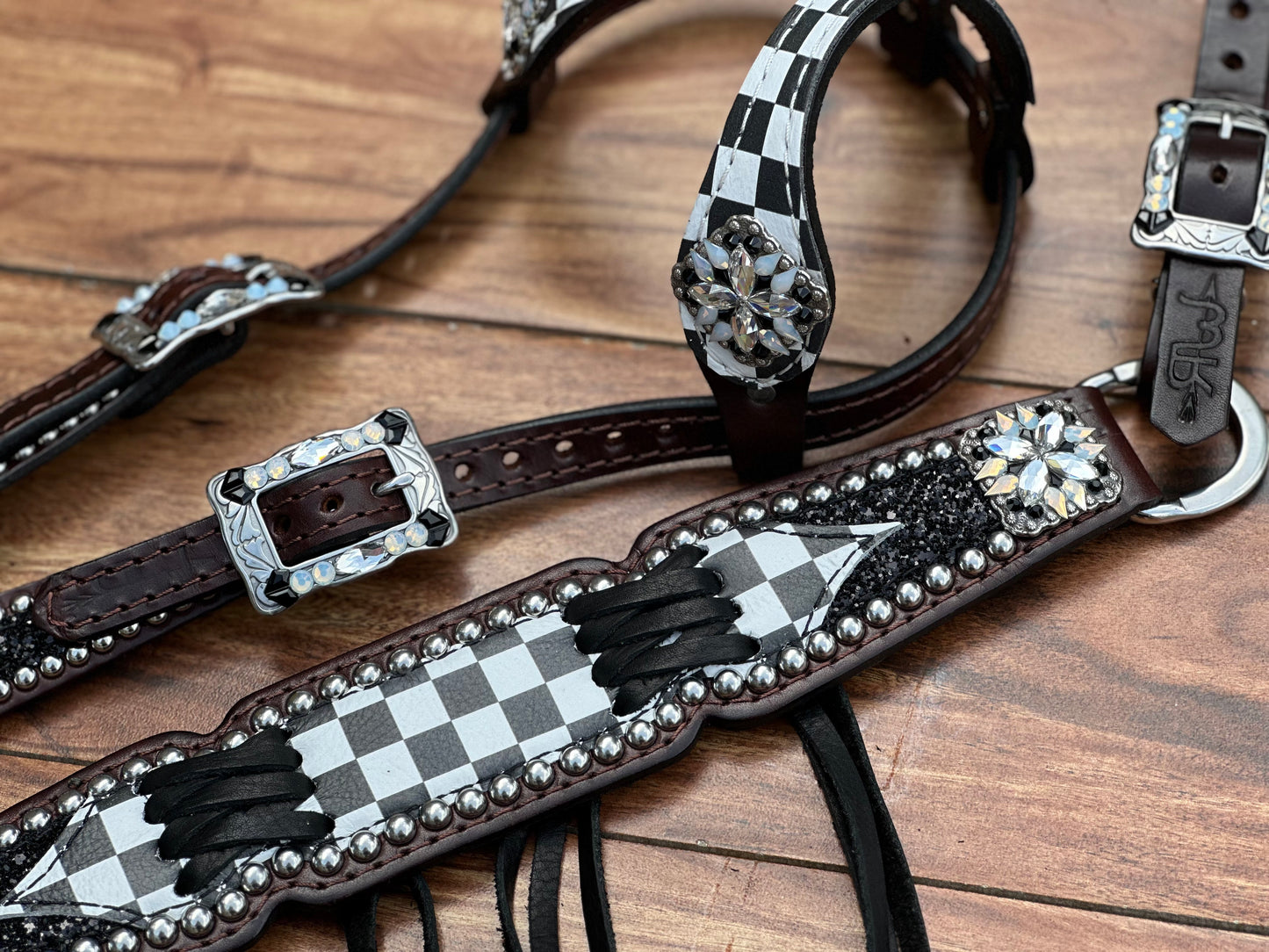 Checked with black chunky glitter. Cross stitch and fringe.
